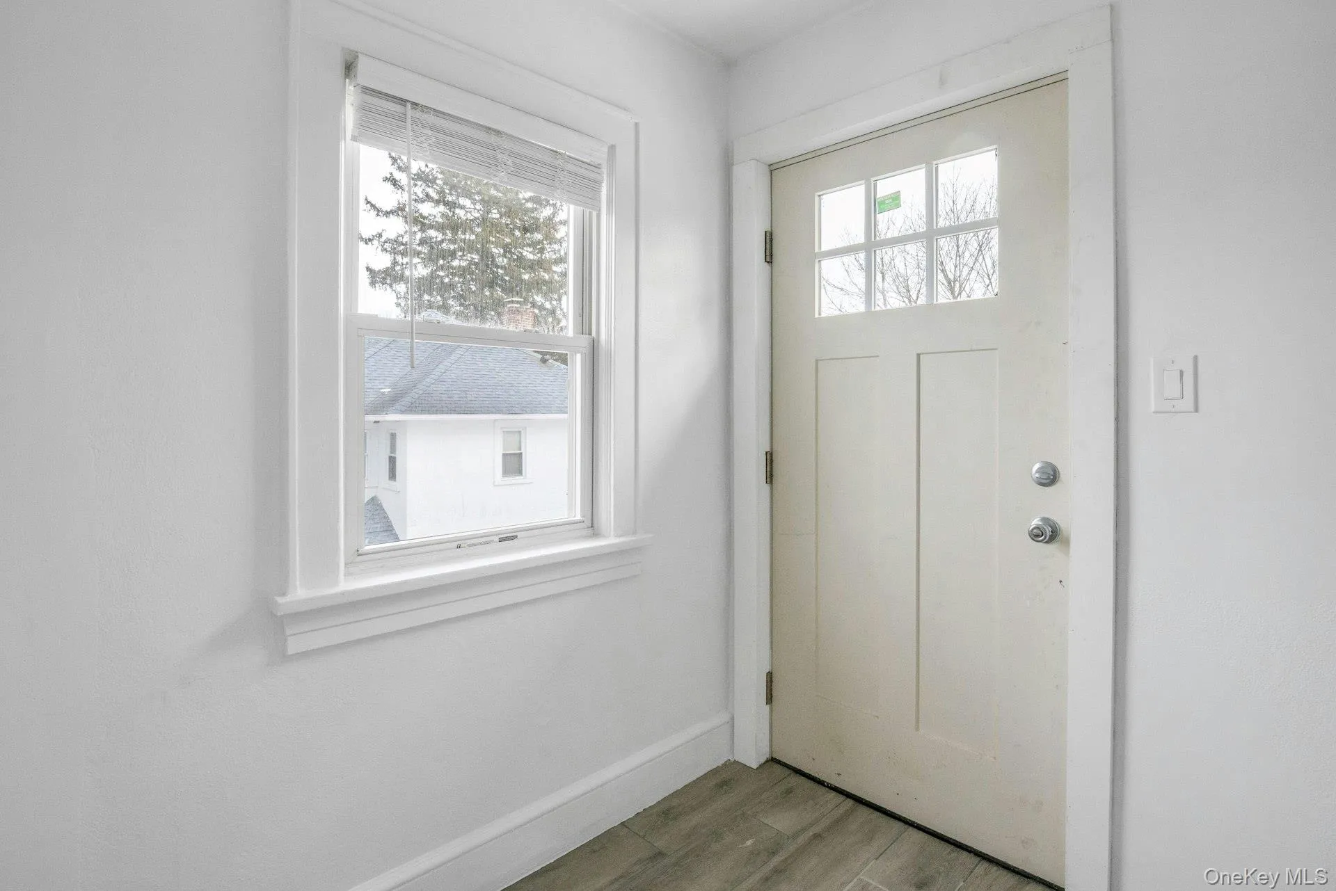 Entryway featuring wood finish floors and baseboards Entryway featuring wood finish floors and baseboards