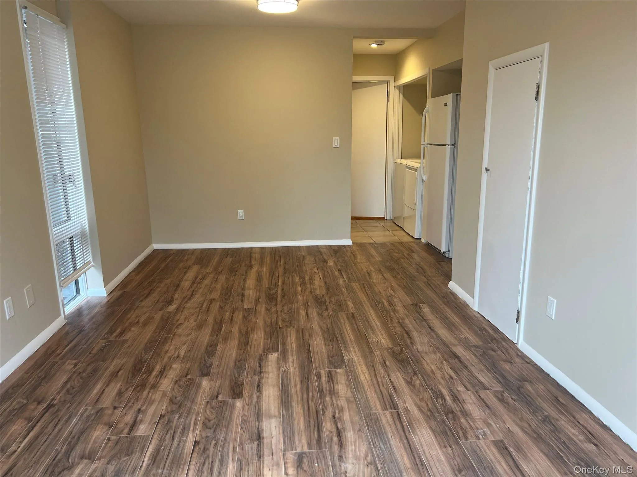 Spare room with dark wood-style floors Spare room with dark wood-style floors