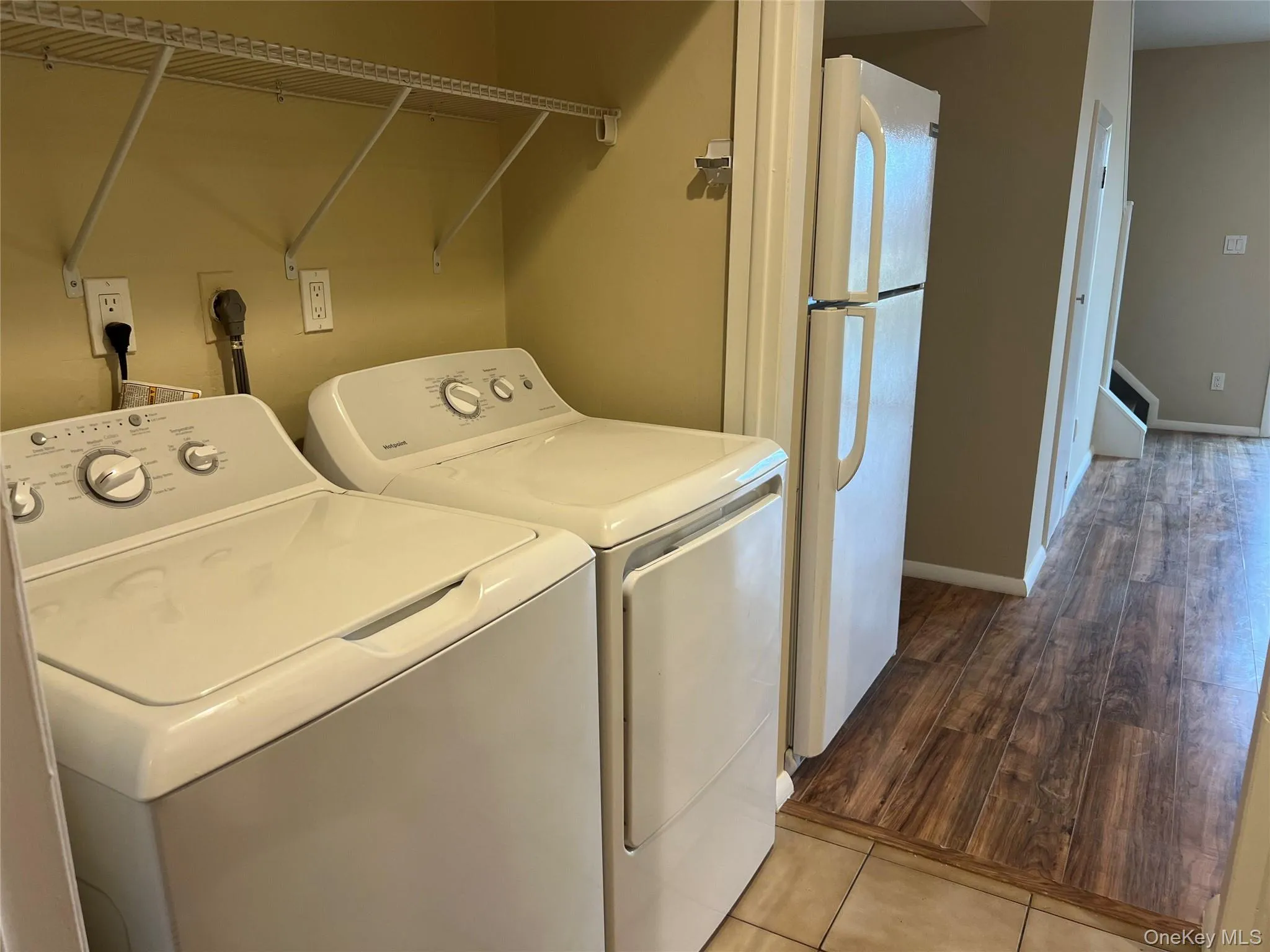 Laundry room featuring separate washer and dryer and light wood-type flooring Laundry room featuring separate washer and dryer and light wood-type flooring