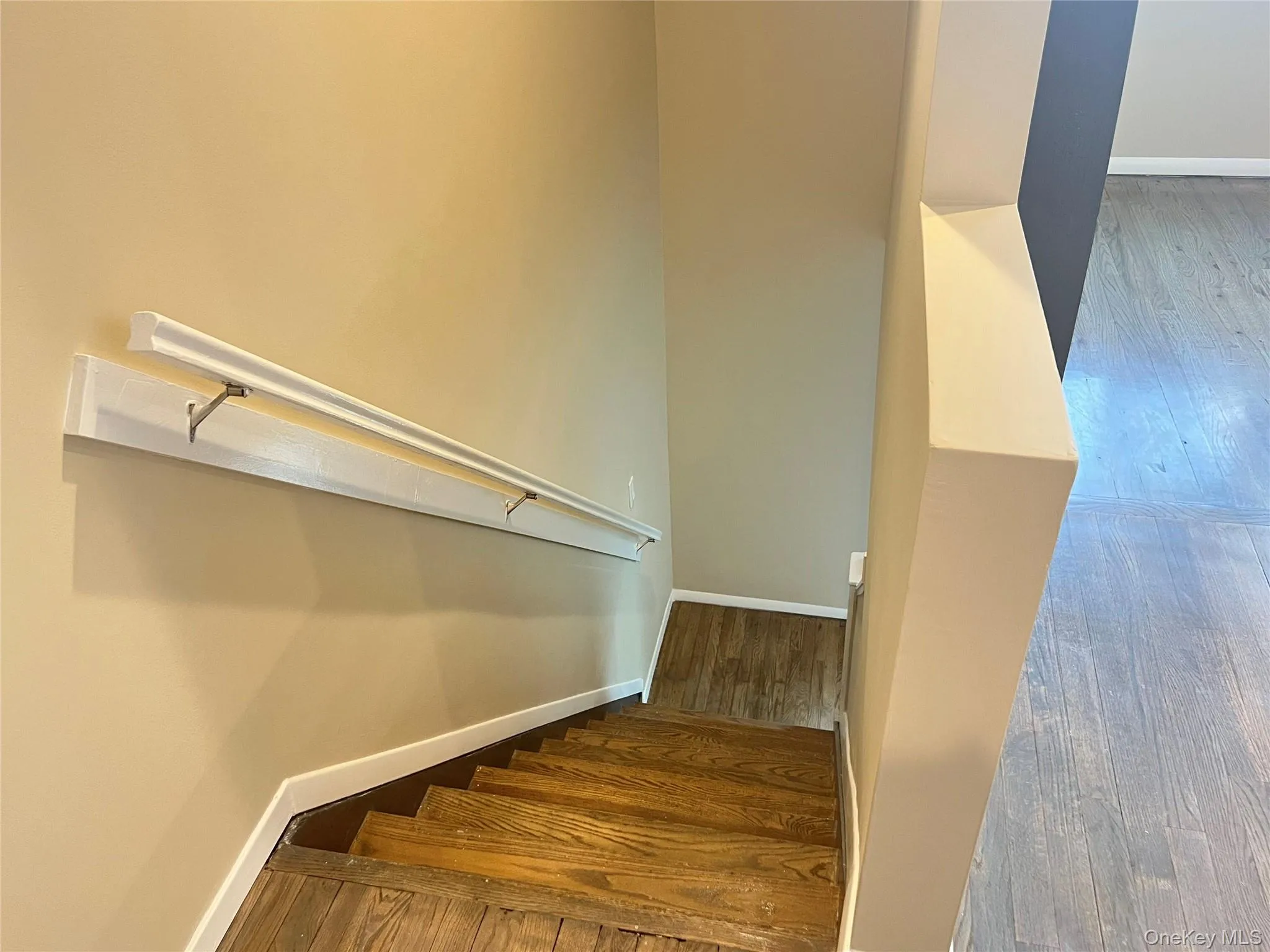 Stairway with wood-type flooring and baseboards Stairway with wood-type flooring and baseboards