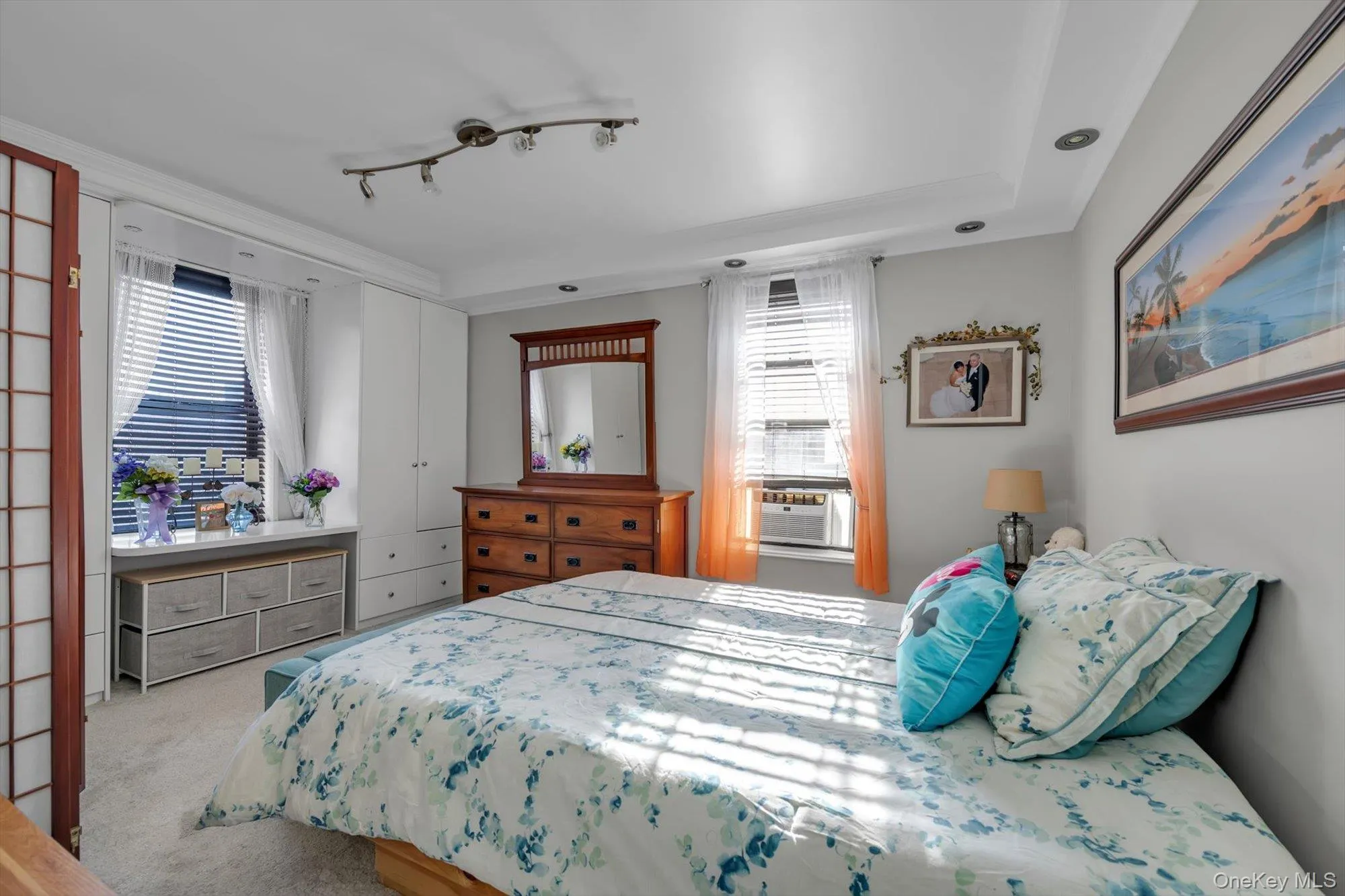 Carpeted bedroom with multiple windows Carpeted bedroom with multiple windows