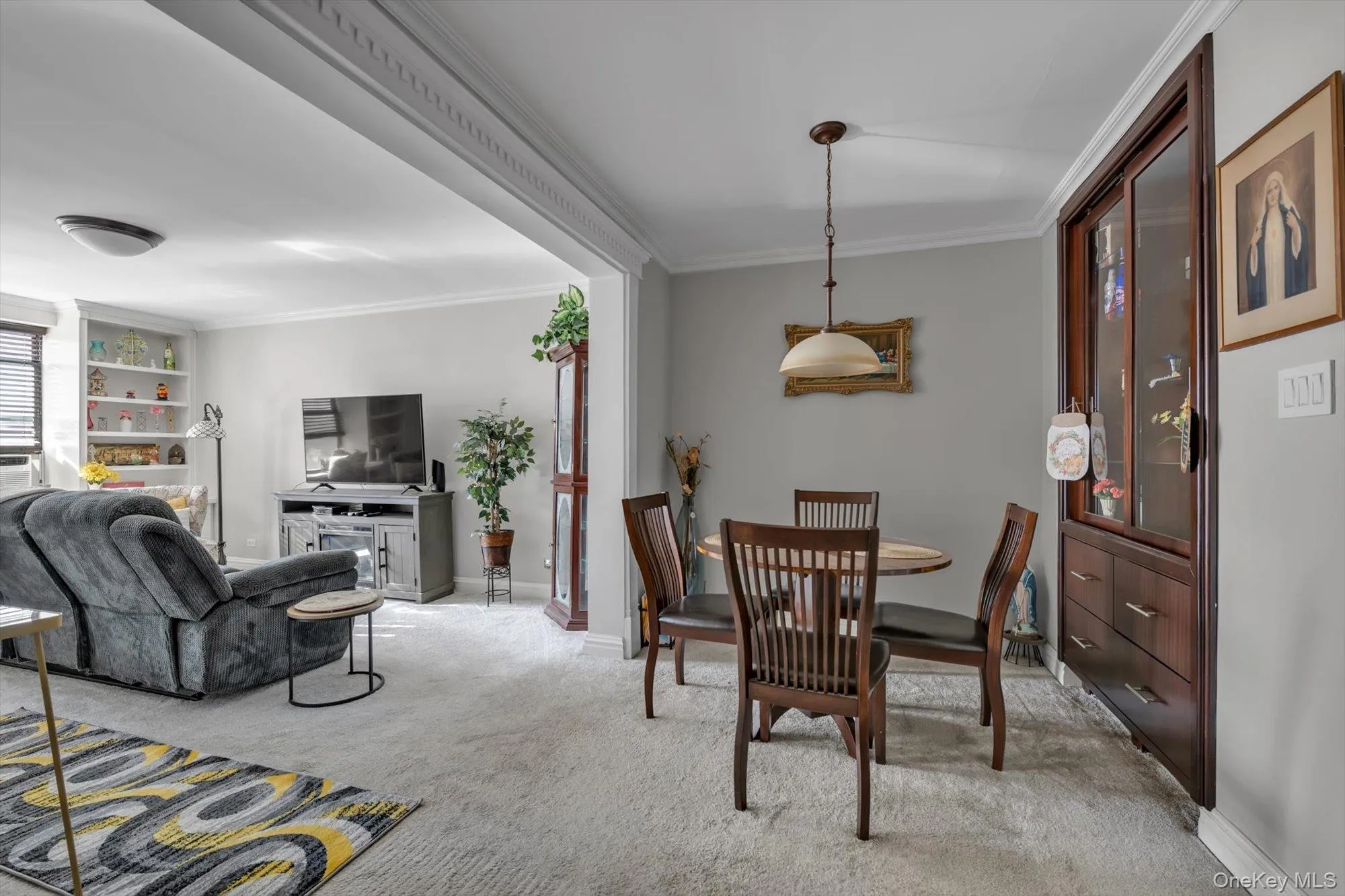 Carpeted dining area with ornamental molding and baseboards Carpeted dining area with ornamental molding and baseboards