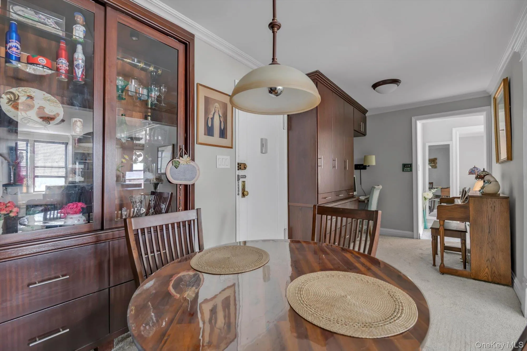 Dining room with crown molding and light colored carpet Dining room with crown molding and light colored carpet
