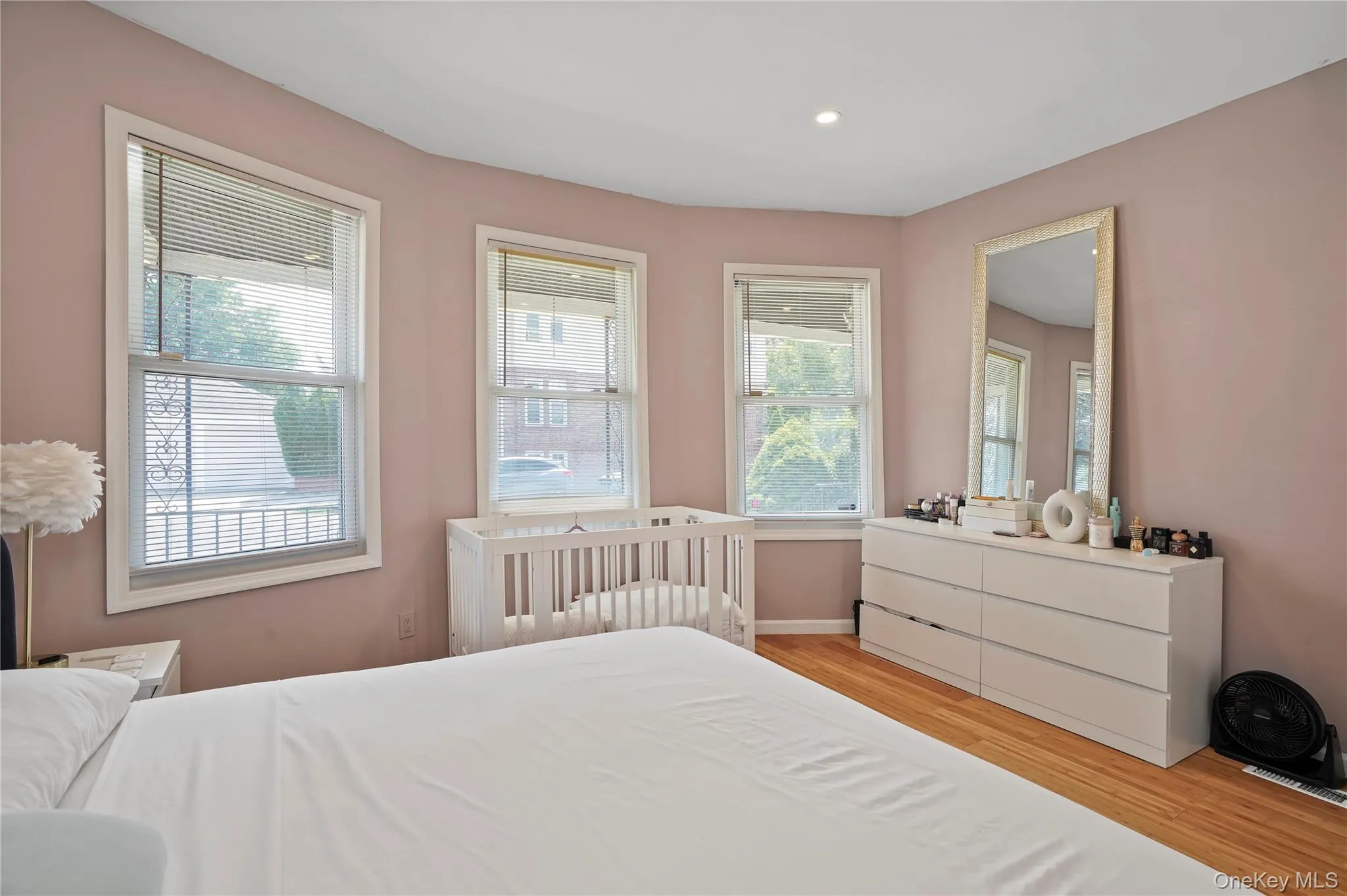 Bedroom with light wood-style floors and recessed lighting Bedroom with light wood-style floors and recessed lighting