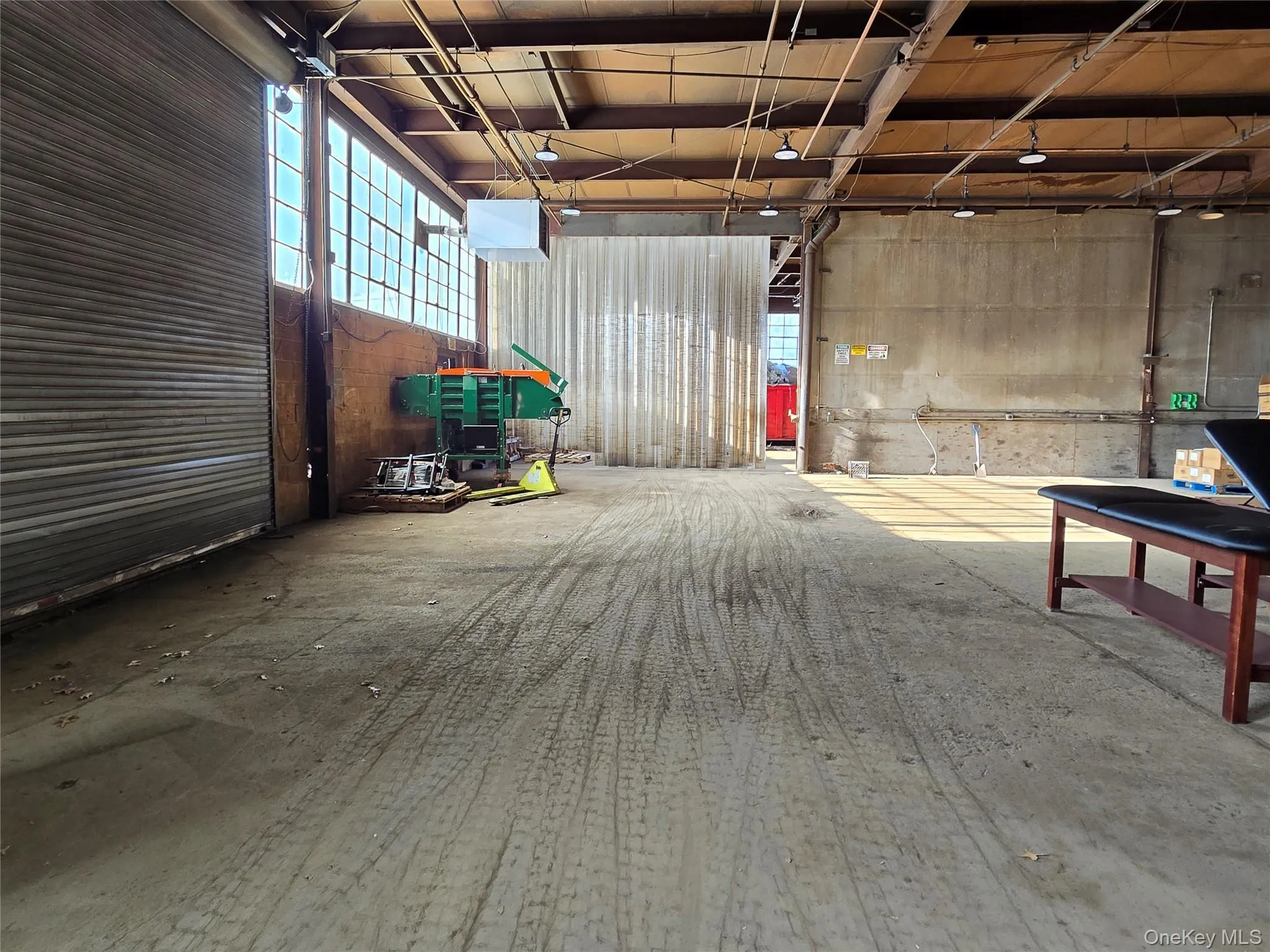 Miscellaneous room featuring a heating unit and a garage Miscellaneous room featuring a heating unit and a garage