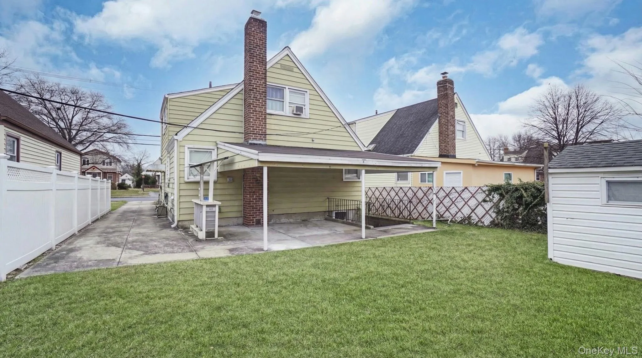 Back of property with a chimney, a fenced backyard, a patio, and a shed Back of property with a chimney, a fenced backyard, a patio, and a shed