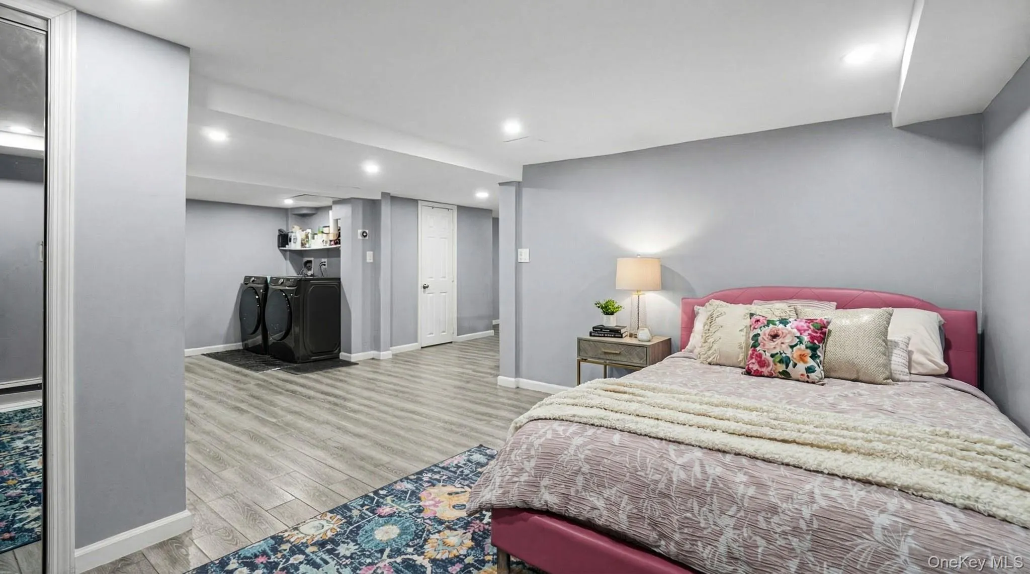 Bedroom featuring light wood-style flooring, recessed lighting, and independent washer and dryer Bedroom featuring light wood-style flooring, recessed lighting, and independent washer and dryer