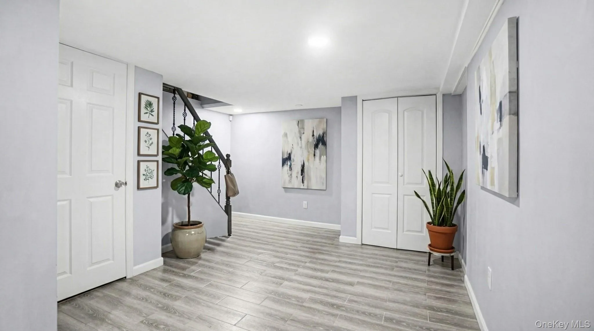 Foyer entrance featuring light wood-type flooring, recessed lighting, and stairway Foyer entrance featuring light wood-type flooring, recessed lighting, and stairway