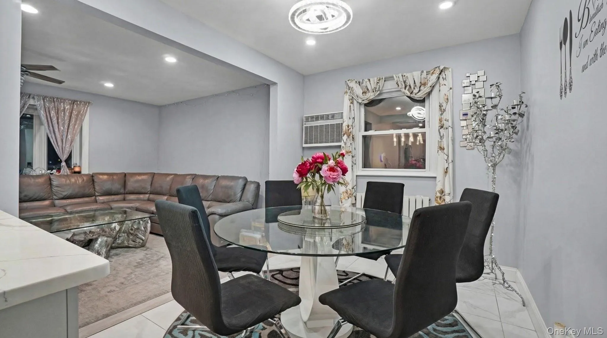 Dining area with recessed lighting, an AC wall unit, and light tile patterned floors Dining area with recessed lighting, an AC wall unit, and light tile patterned floors