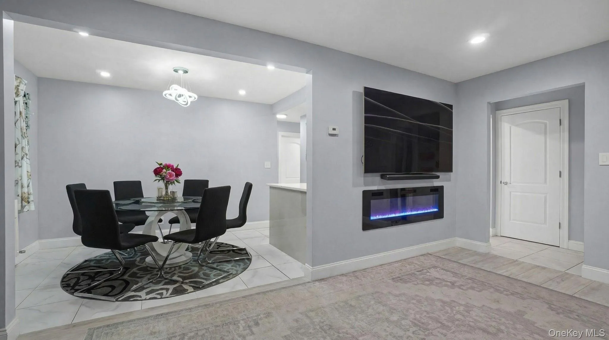 Dining area featuring recessed lighting and a glass covered fireplace Dining area featuring recessed lighting and a glass covered fireplace