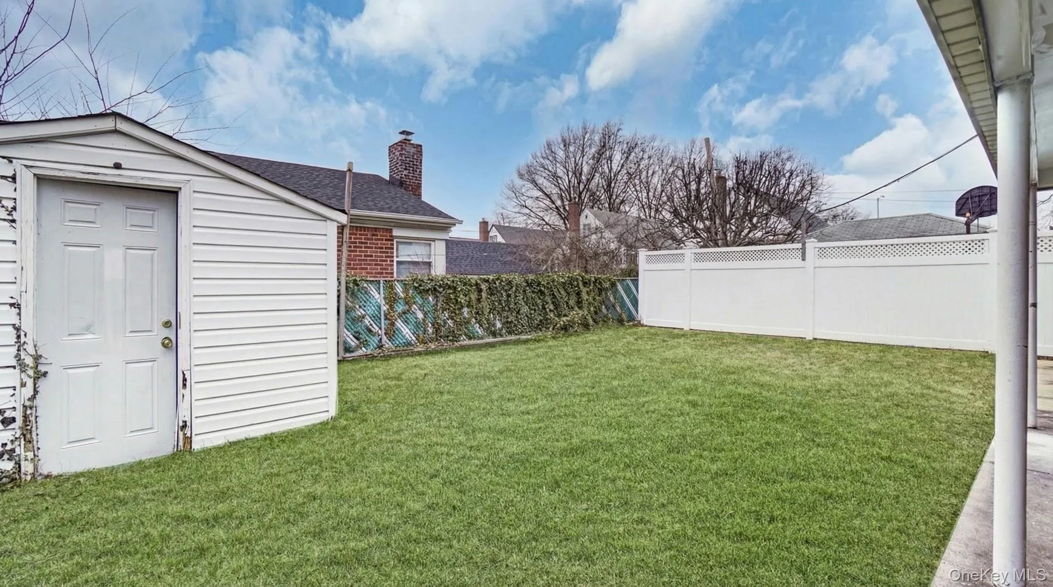 Fenced backyard featuring a storage unit Fenced backyard featuring a storage unit