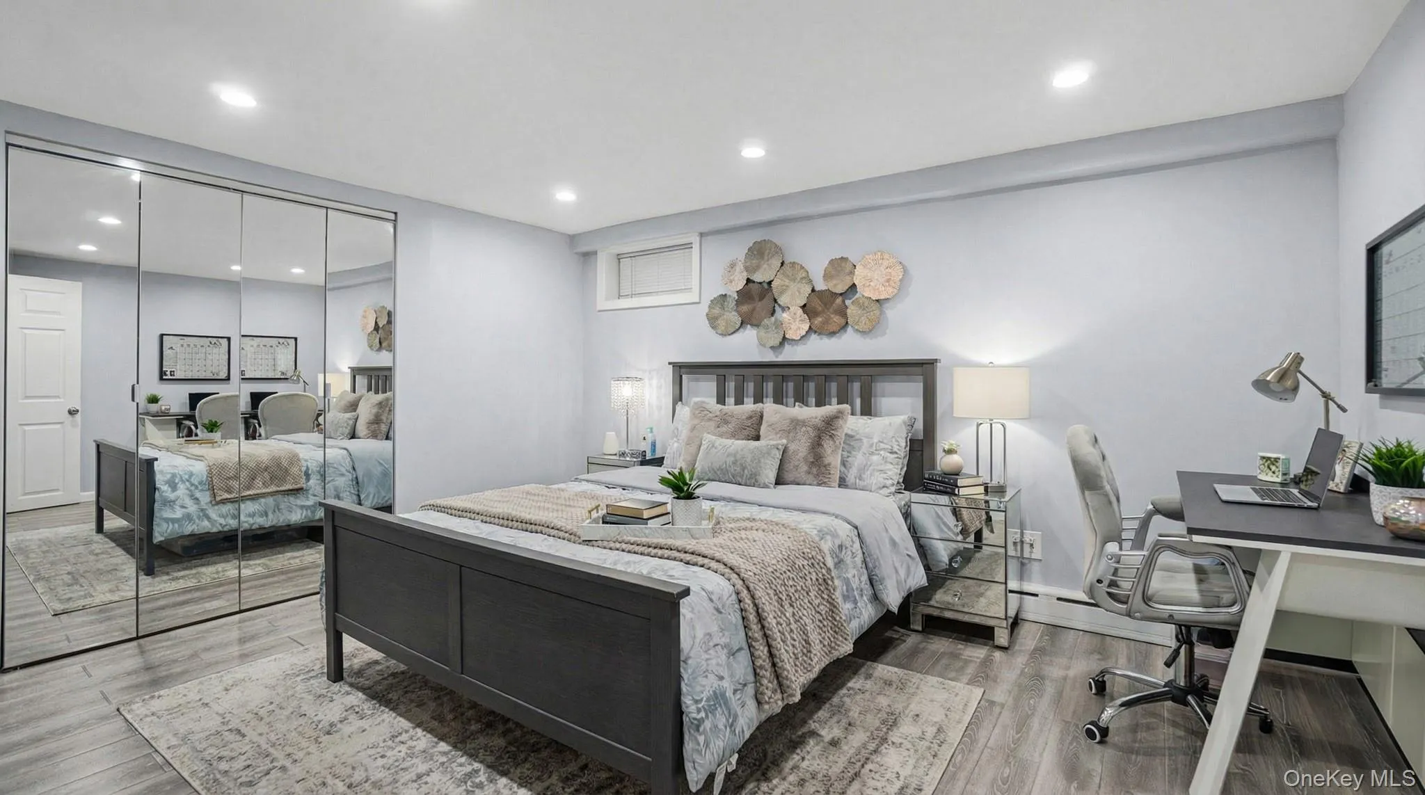 Bedroom with an office area, recessed lighting, wood finished floors, and a closet Bedroom with an office area, recessed lighting, wood finished floors, and a closet