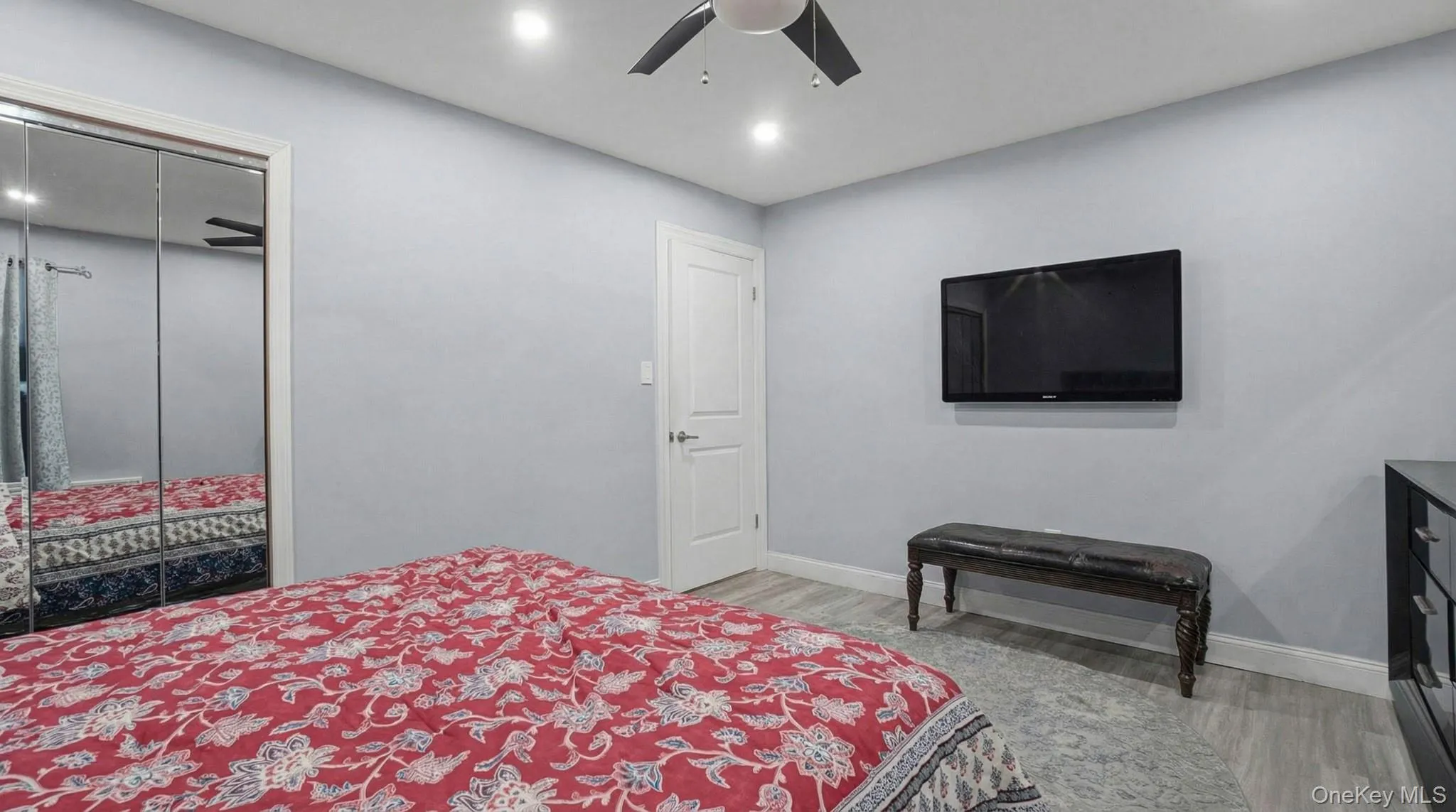 Bedroom featuring light wood-style flooring, recessed lighting, ceiling fan, and a closet Bedroom featuring light wood-style flooring, recessed lighting, ceiling fan, and a closet