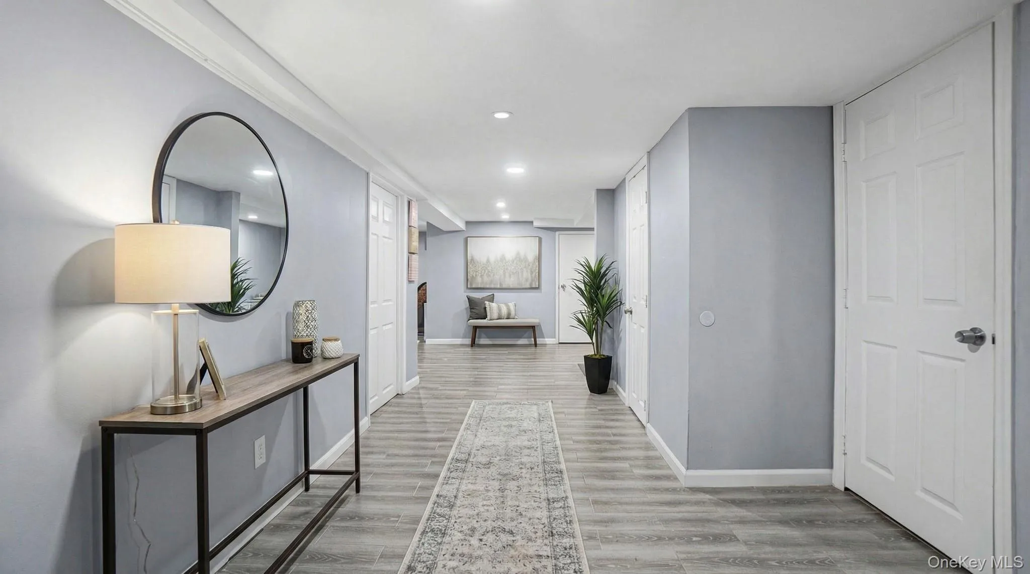 Hall with light wood-type flooring and recessed lighting Hall with light wood-type flooring and recessed lighting