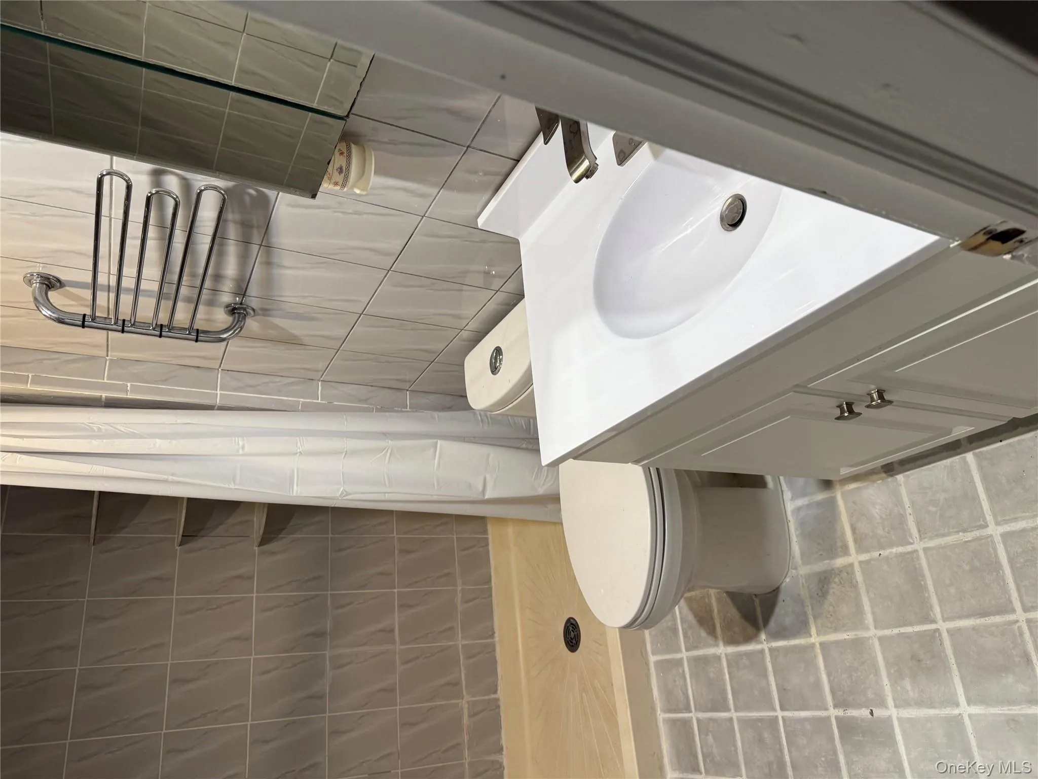 Full bathroom with vanity, a stall shower, and tile walls Full bathroom with vanity, a stall shower, and tile walls