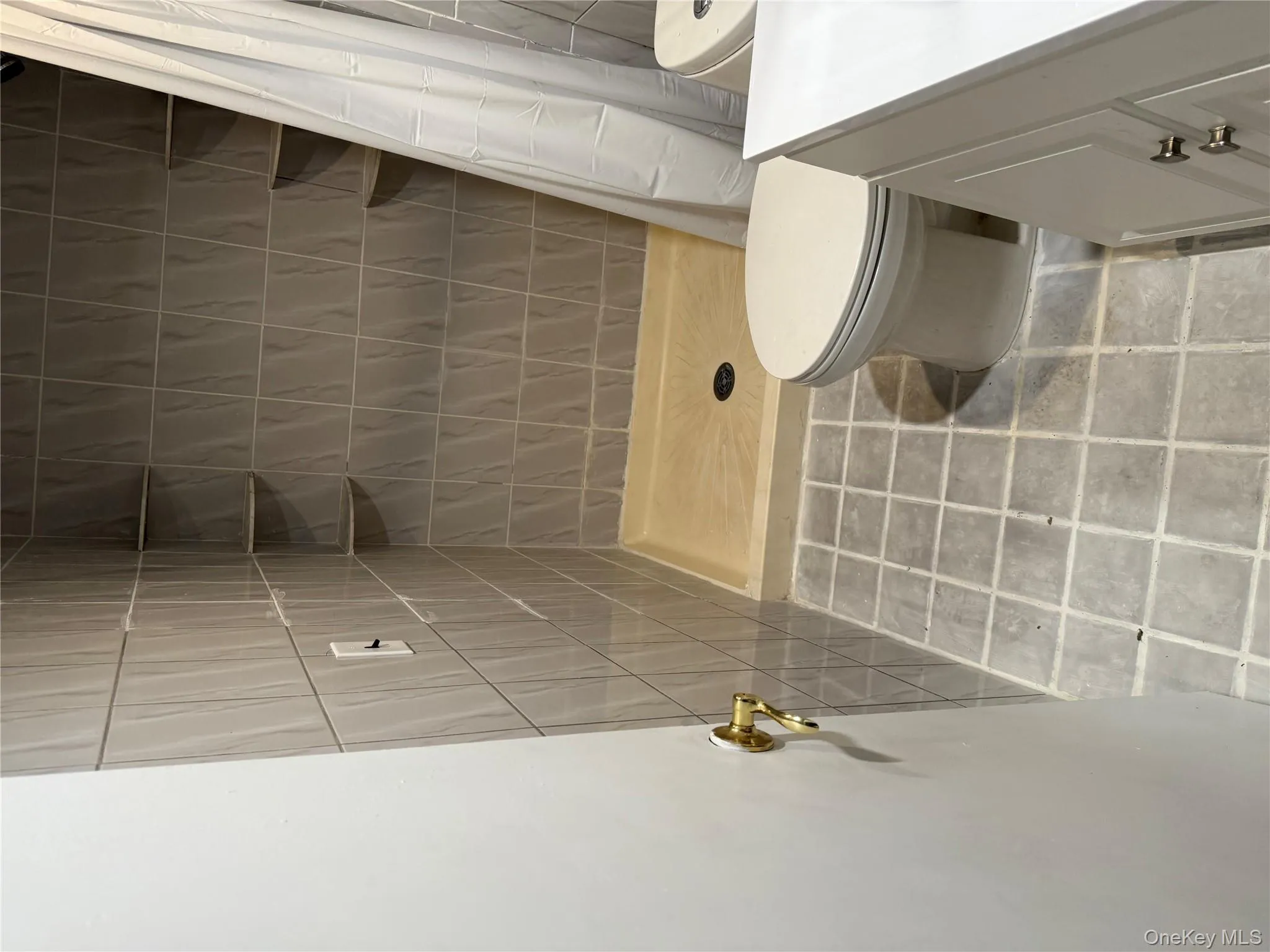 Bathroom with a stall shower, vanity, and light tile patterned flooring Bathroom with a stall shower, vanity, and light tile patterned flooring