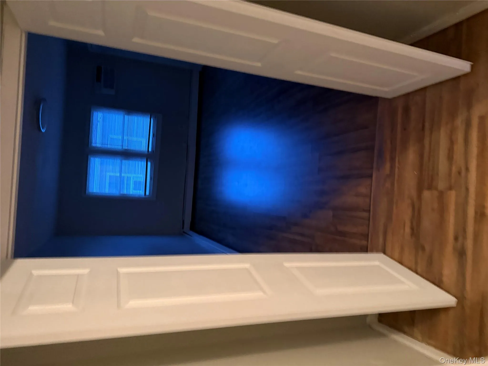 Spare room with dark wood-style floors and baseboards Spare room with dark wood-style floors and baseboards