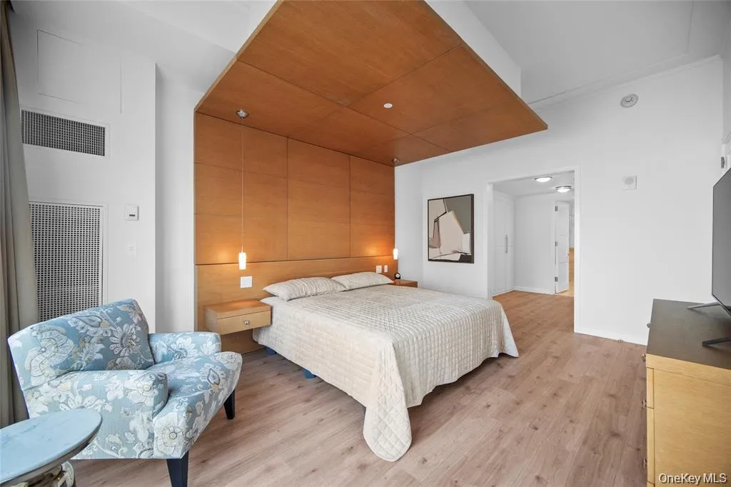 Bedroom featuring light wood finished floors and recessed lighting Bedroom featuring light wood finished floors and recessed lighting
