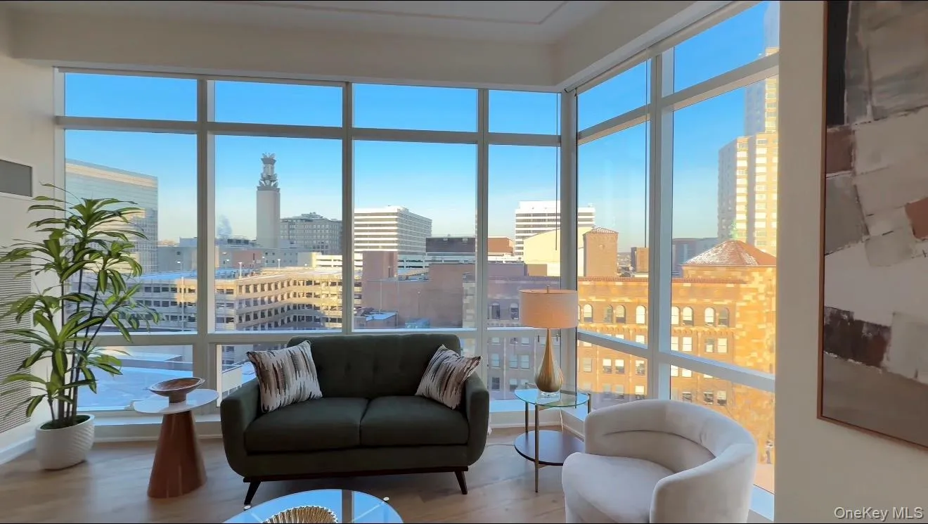 Sunroom featuring a city view and plenty of natural light Sunroom featuring a city view and plenty of natural light