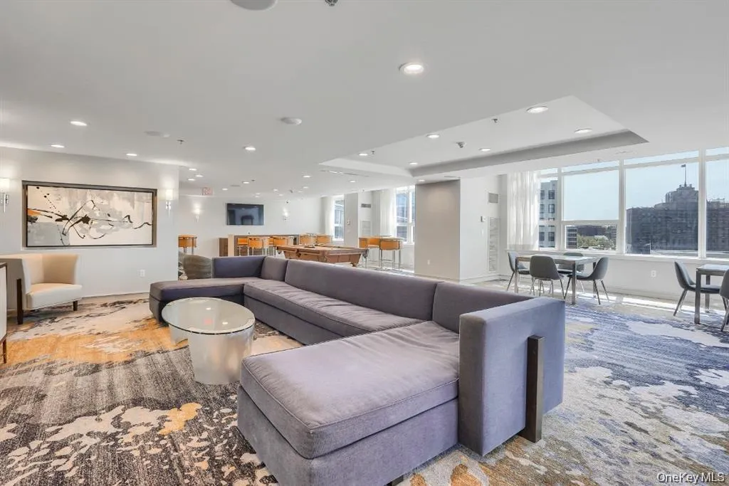 Living area featuring a raised ceiling and recessed lighting Living area featuring a raised ceiling and recessed lighting