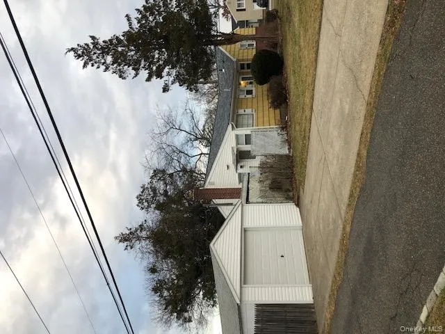 View of front of home featuring driveway, an outdoor structure, and a chimney View of front of home featuring driveway, an outdoor structure, and a chimney