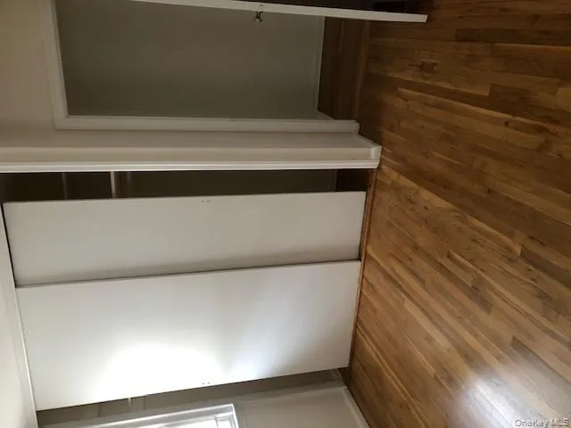 Unfurnished bedroom featuring dark wood finished floors and a closet Unfurnished bedroom featuring dark wood finished floors and a closet