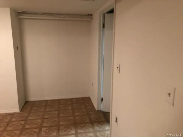 Hall featuring light flooring and baseboards Hall featuring light flooring and baseboards