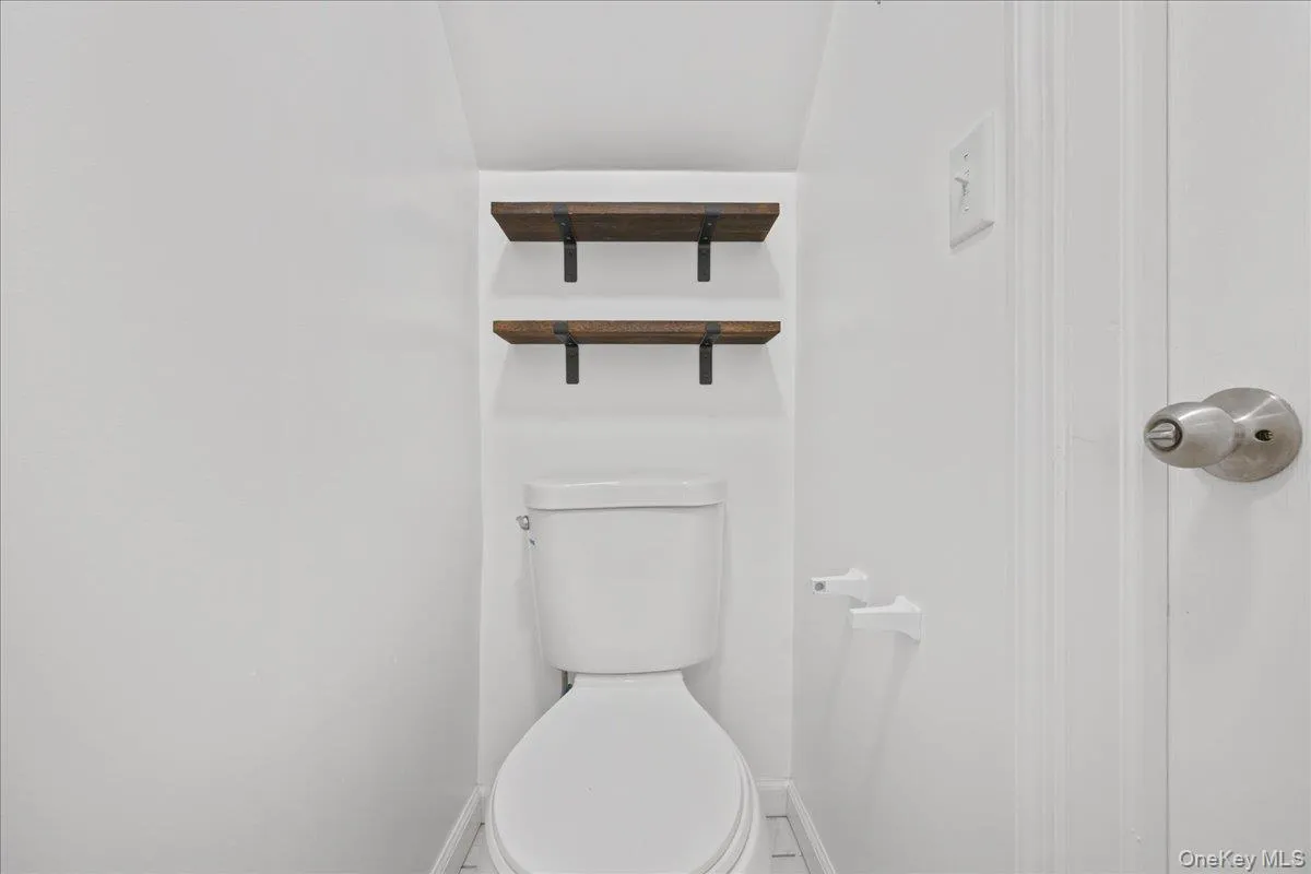 Bathroom with toilet and baseboards Bathroom with toilet and baseboards