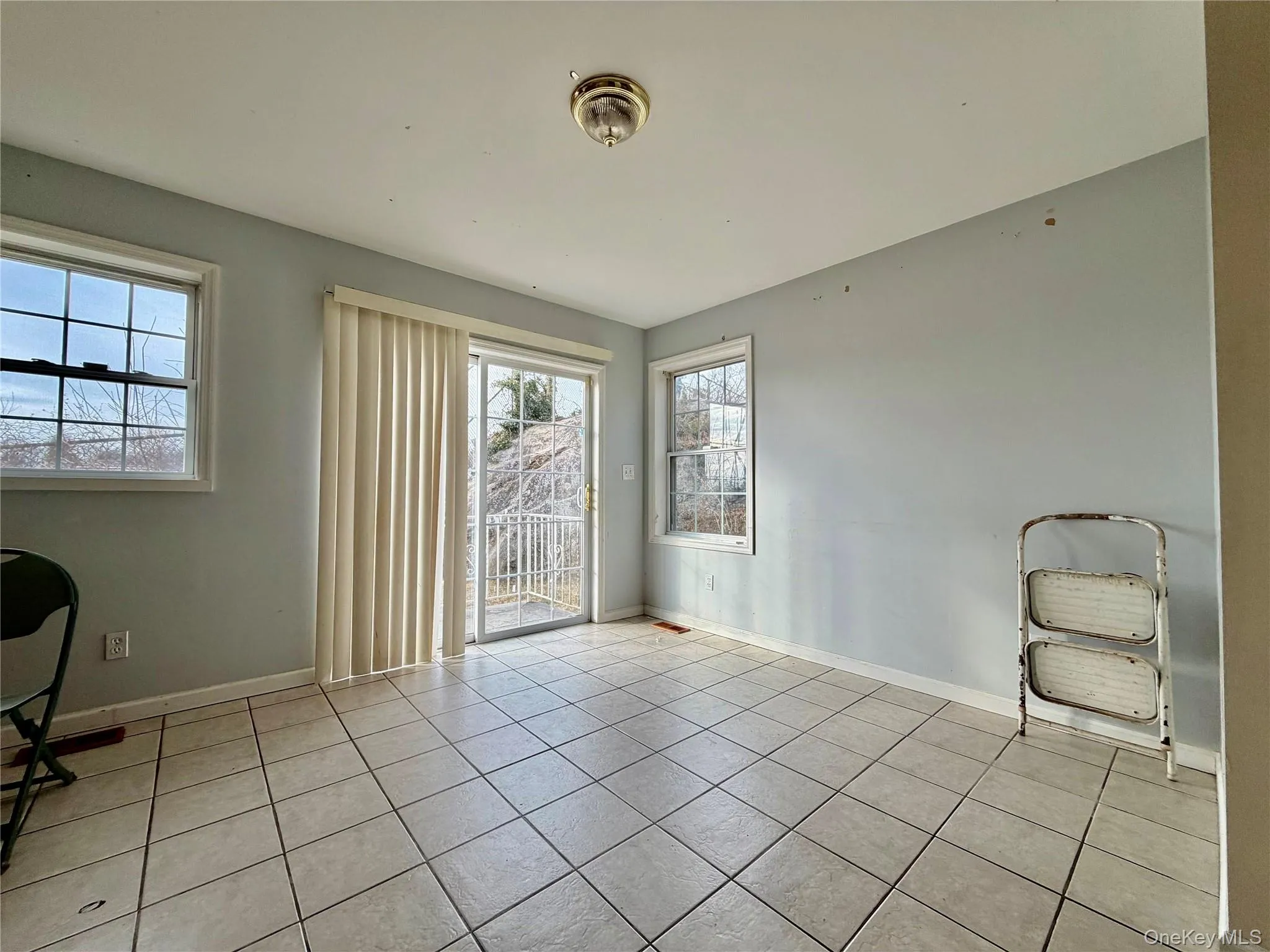 Unfurnished dining area featuring baseboards and light tile patterned flooring Unfurnished dining area featuring baseboards and light tile patterned flooring