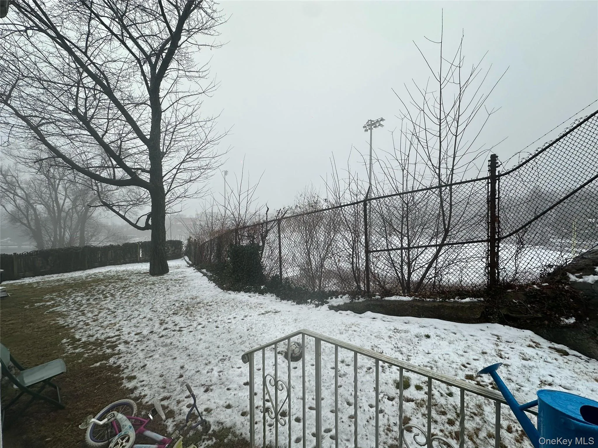 Yard layered in snow featuring a fenced backyard Yard layered in snow featuring a fenced backyard