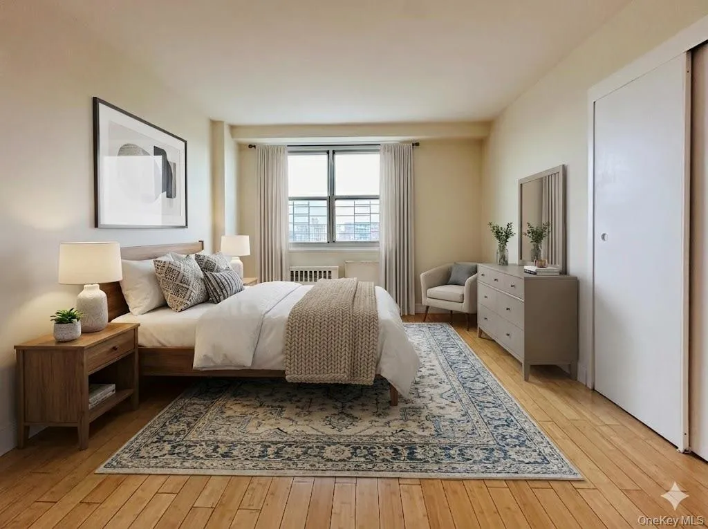 Bedroom featuring light wood-style flooring and radiator heating unit Bedroom featuring light wood-style flooring and radiator heating unit
