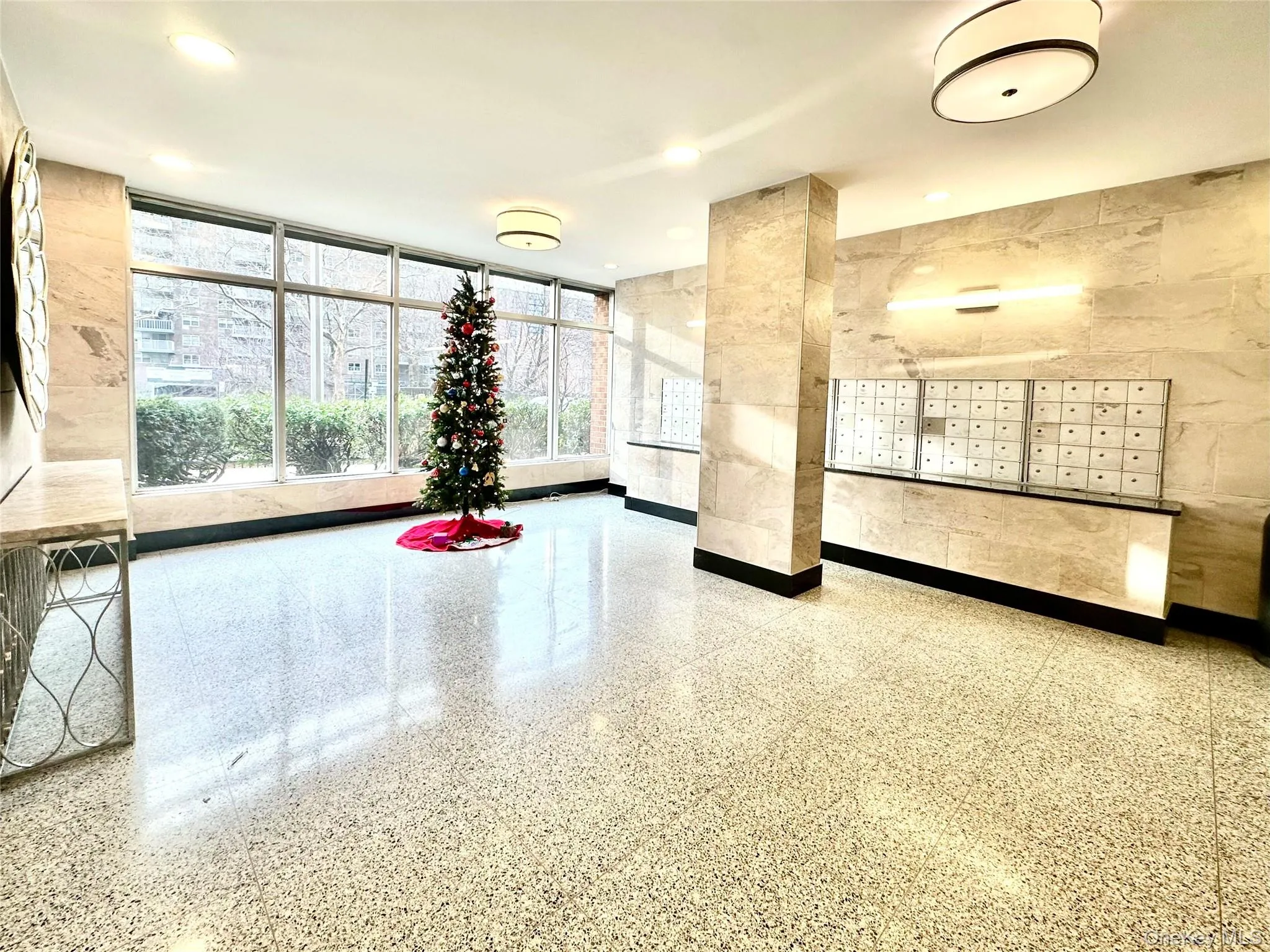Common area featuring tile walls, a wall of windows, and recessed lighting Common area featuring tile walls, a wall of windows, and recessed lighting