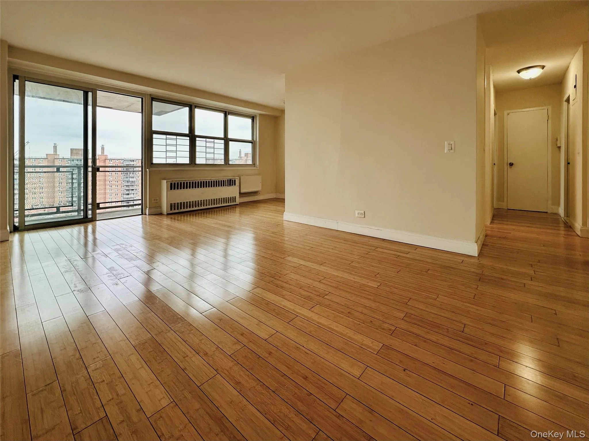 Spare room with light wood-style flooring and radiator heating unit Spare room with light wood-style flooring and radiator heating unit