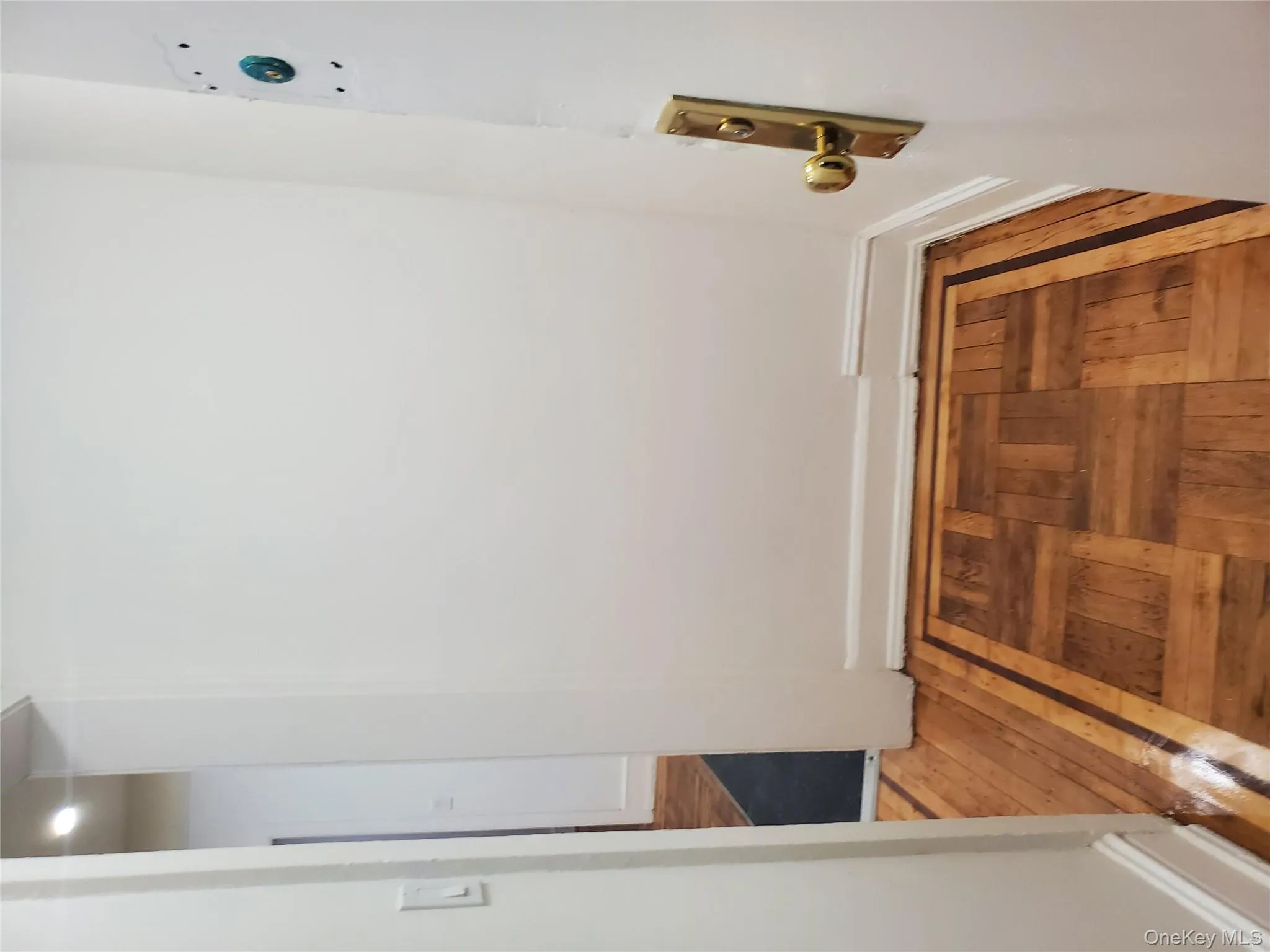 Corridor featuring hardwood / wood-style floors and baseboards Corridor featuring hardwood / wood-style floors and baseboards