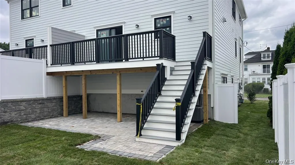 Rear view of property featuring a patio area, stairway, and a wooden deck Rear view of property featuring a patio area, stairway, and a wooden deck