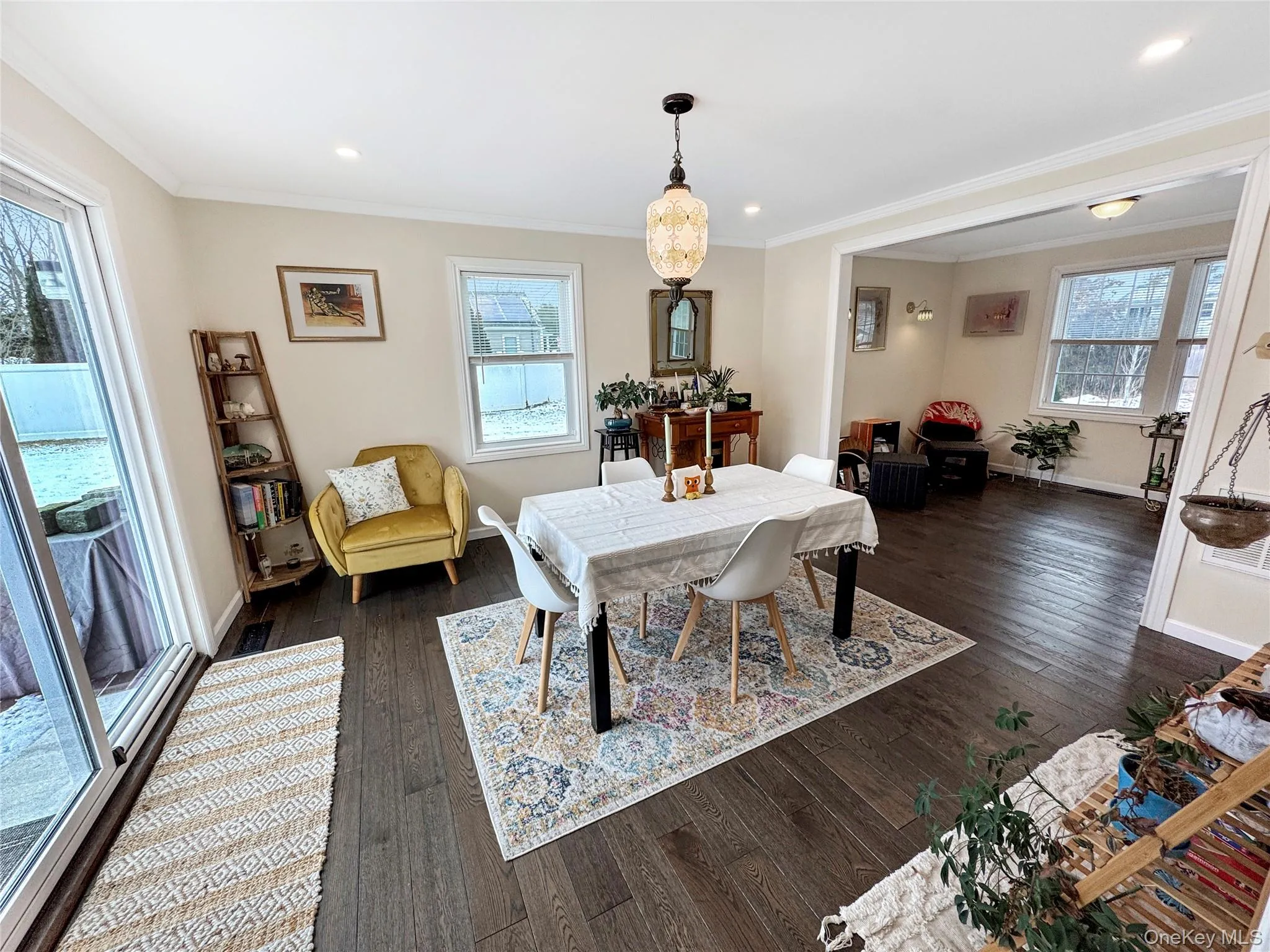 Dining room with plenty of natural light, dark wood-type flooring, ornamental molding, and recessed lighting Dining room with plenty of natural light, dark wood-type flooring, ornamental molding, and recessed lighting