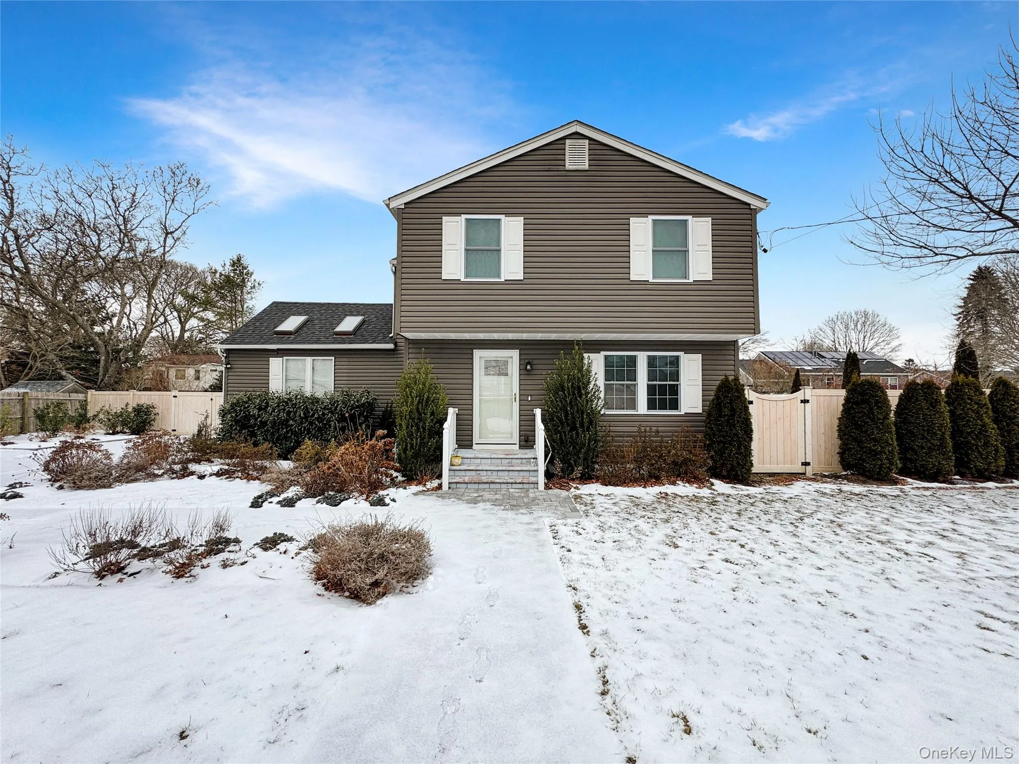 Colonial-style house featuring a gate Colonial-style house featuring a gate