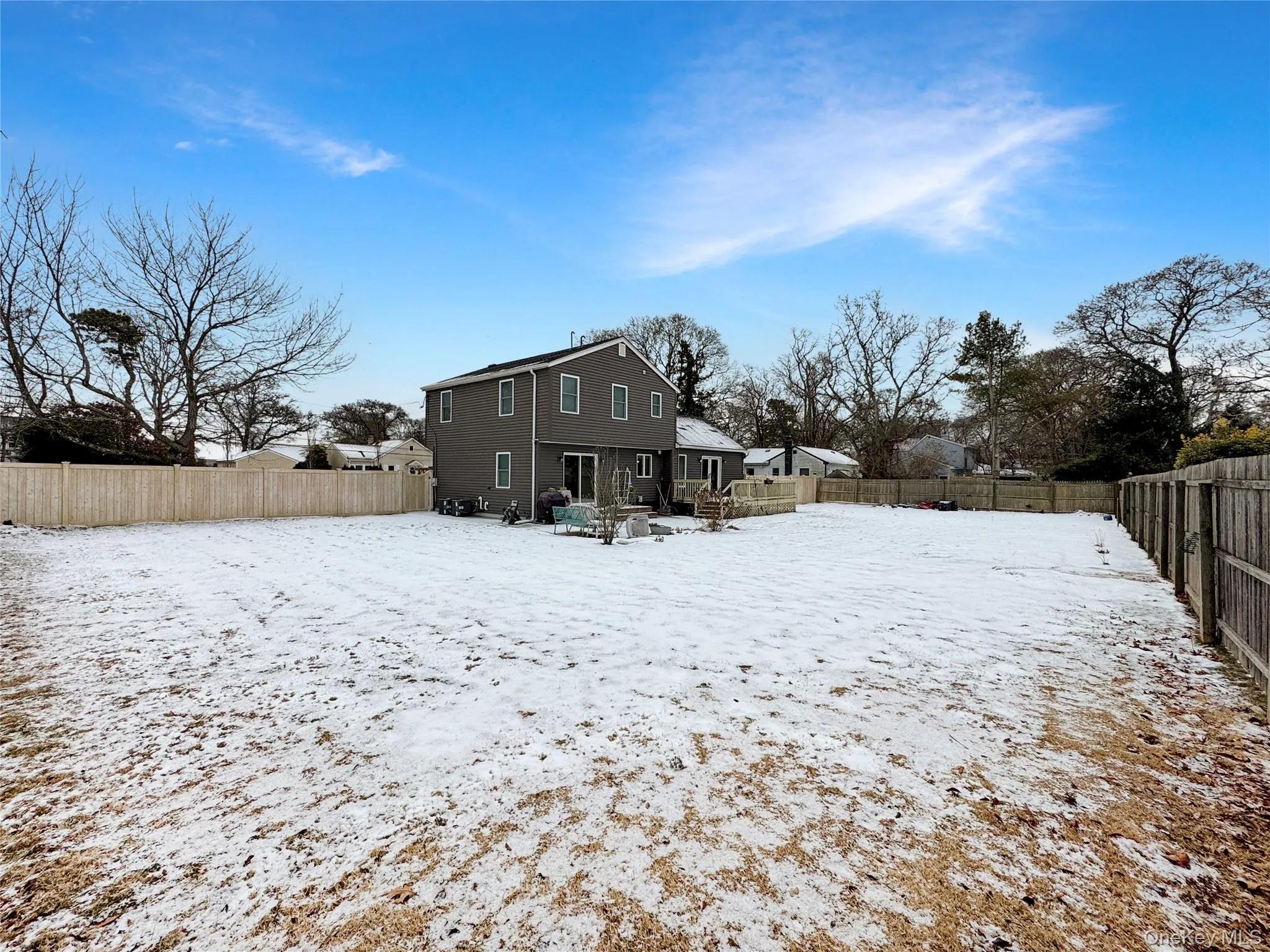 Snow covered property with a fenced backyard Snow covered property with a fenced backyard