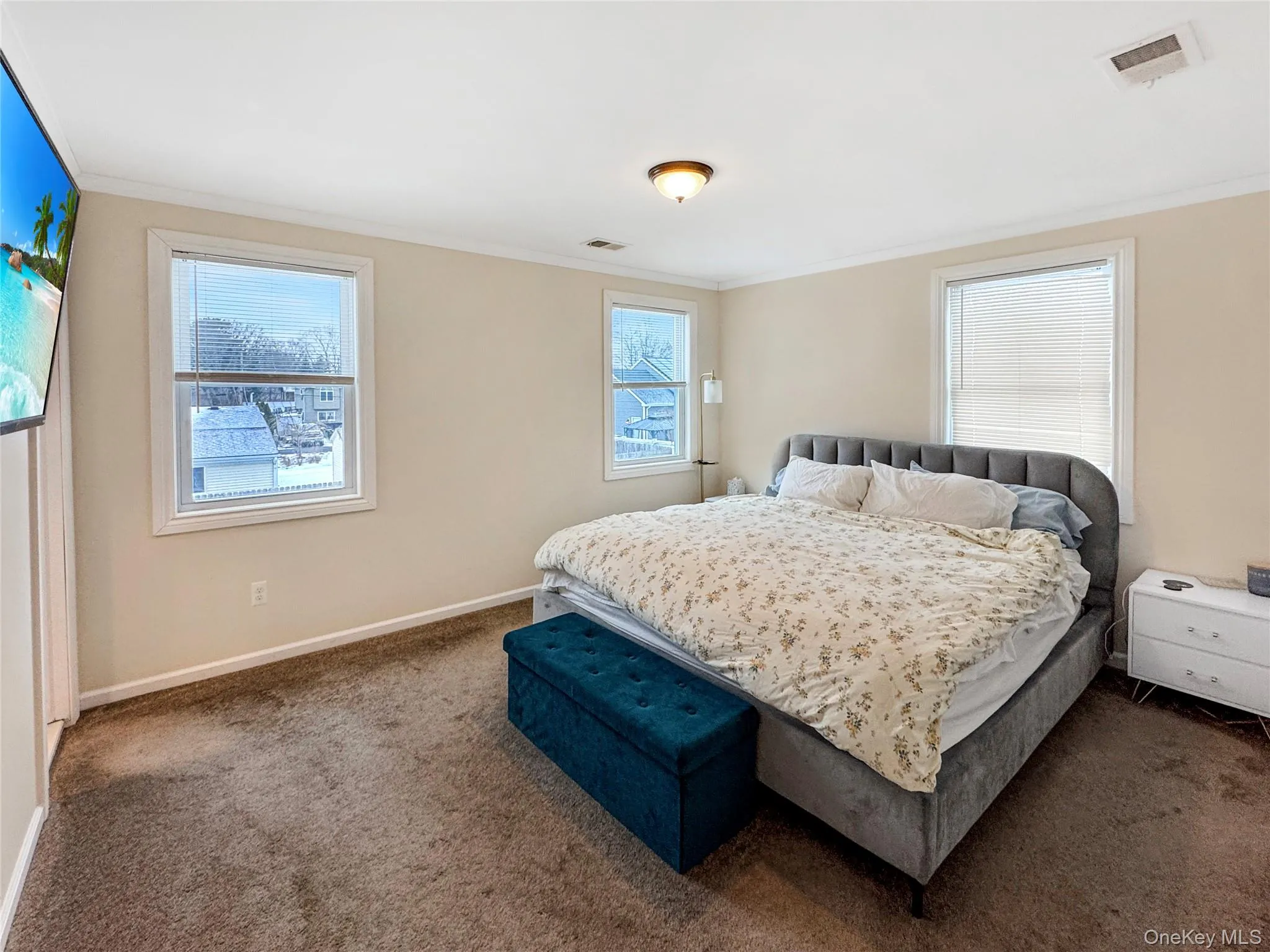 Carpeted bedroom featuring crown molding Carpeted bedroom featuring crown molding