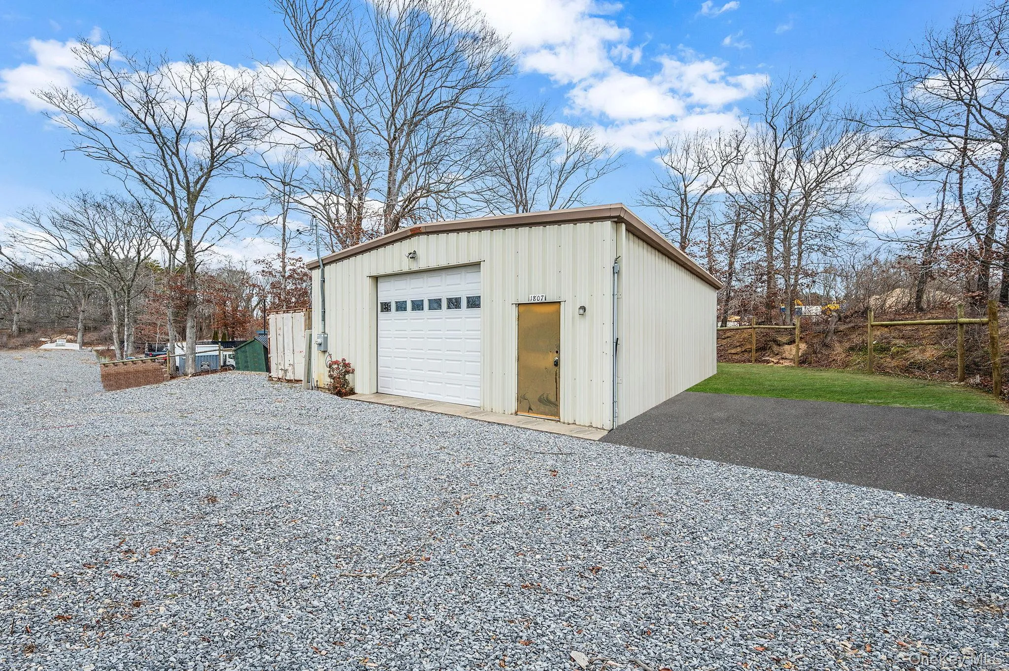 Detached garage featuring gravel driveway Detached garage featuring gravel driveway