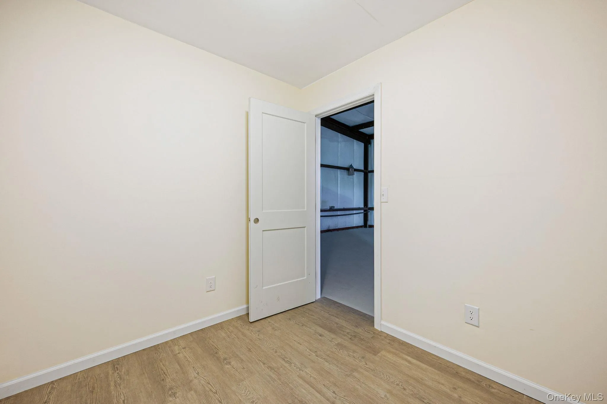 Unfurnished bedroom with baseboards and light wood-style floors Unfurnished bedroom with baseboards and light wood-style floors