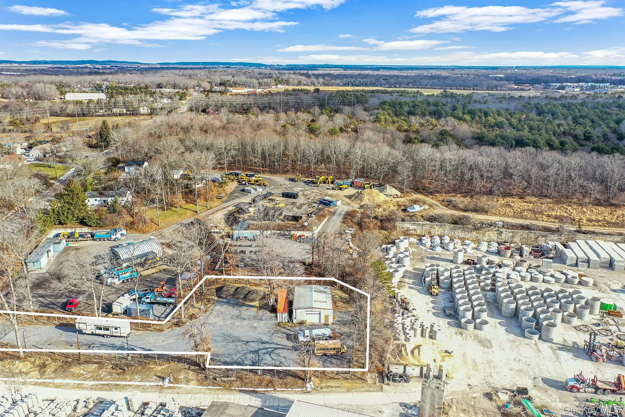 Aerial overview of property's location featuring property parcel outlined and an industrial area Aerial overview of property's location featuring property parcel outlined and an industrial area