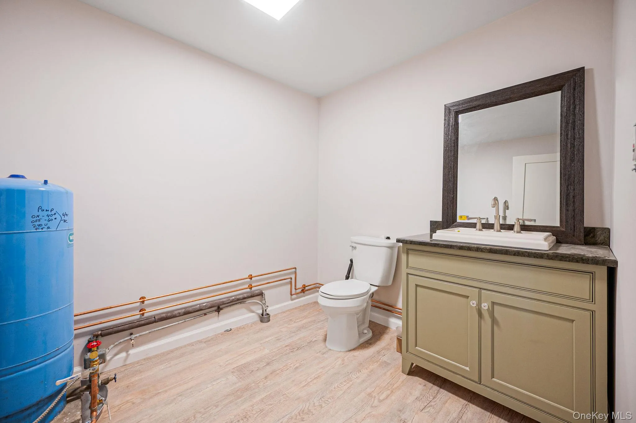Bathroom featuring vanity and light wood-style floors Bathroom featuring vanity and light wood-style floors