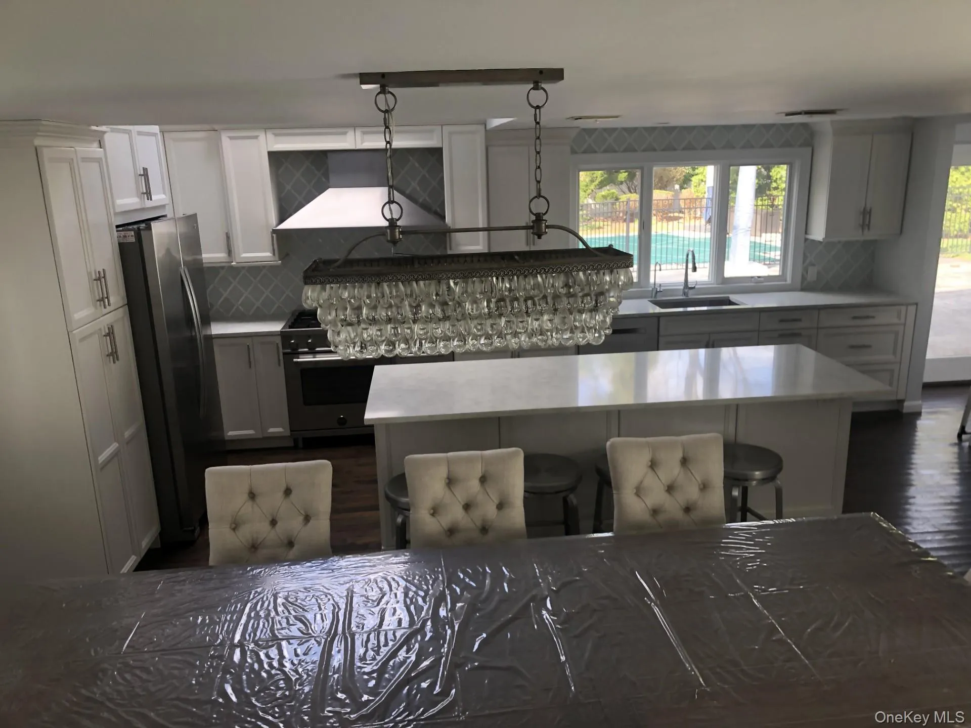 Open kitchen with island seating and full table seating. Open kitchen with island seating and full table seating.