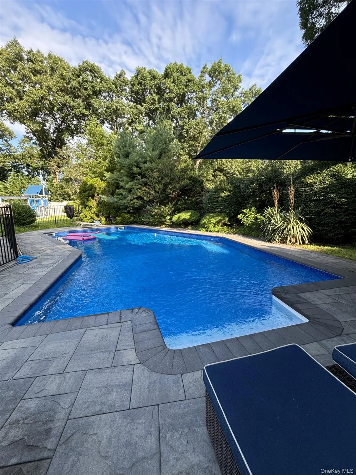 View of pool with a fenced in pool, a patio, fence, and a jacuzzi View of pool with a fenced in pool, a patio, fence, and a jacuzzi