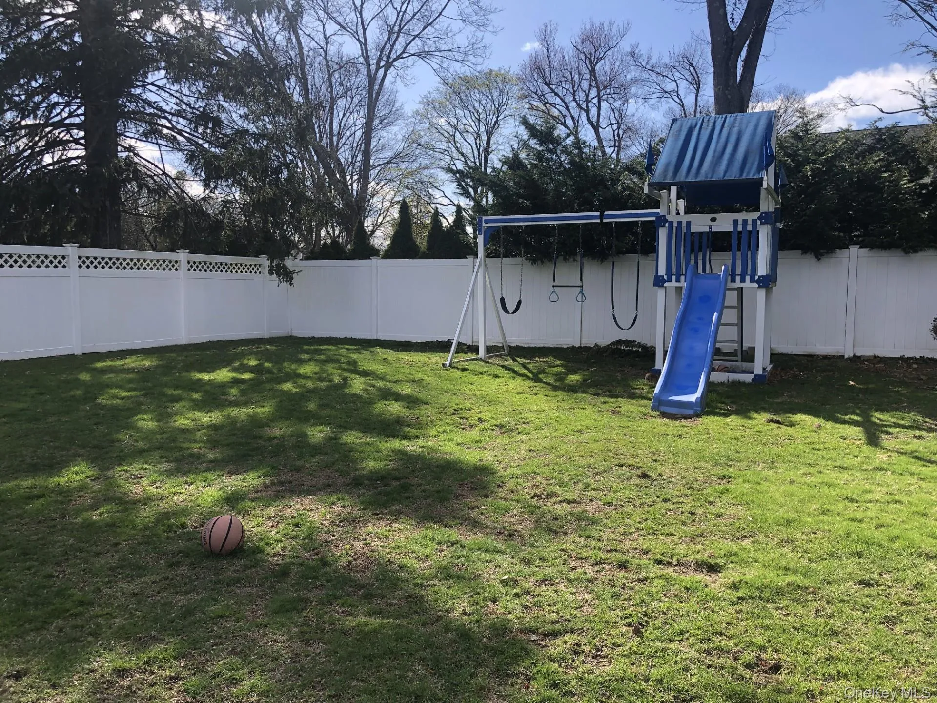 View of yard featuring a fenced backyard and a playground View of yard featuring a fenced backyard and a playground