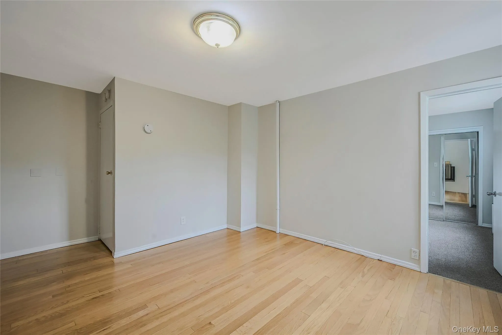 Unfurnished room featuring light wood-style floors and baseboards Unfurnished room featuring light wood-style floors and baseboards
