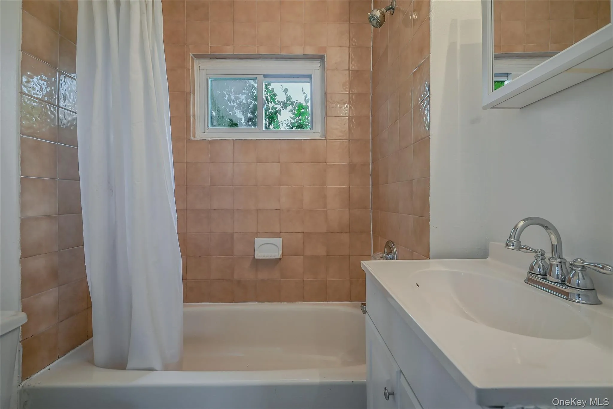 Full bath featuring vanity and shower / bathtub combination with curtain Full bath featuring vanity and shower / bathtub combination with curtain