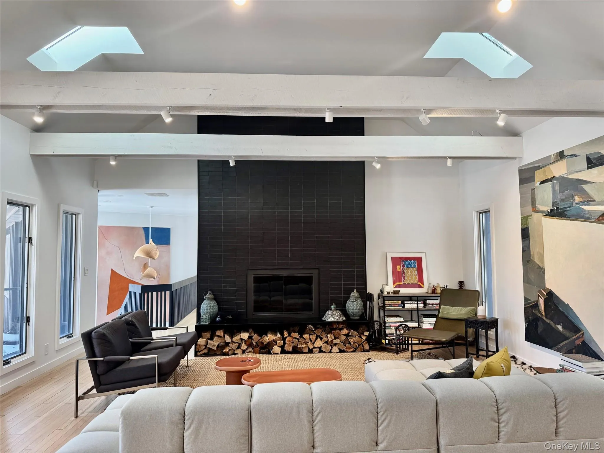 Living area with a skylights, a fireplace, beamed ceiling, and wood finished floors, with great views and lots of windows Living area with a skylights, a fireplace, beamed ceiling, and wood finished floors, with great views and lots of windows