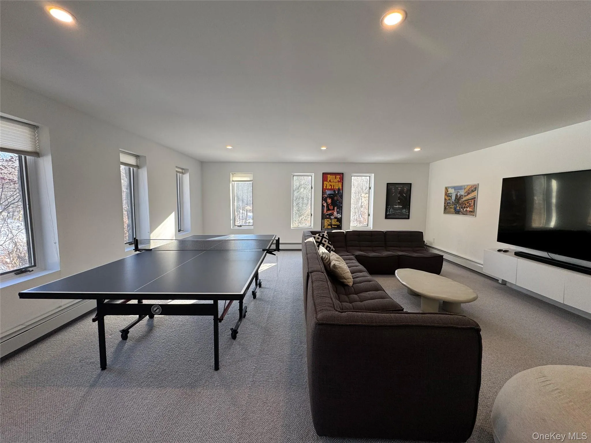 Playroom featuring recessed lighting, carpet floors, and a baseboard heating unit Playroom featuring recessed lighting, carpet floors, and a baseboard heating unit